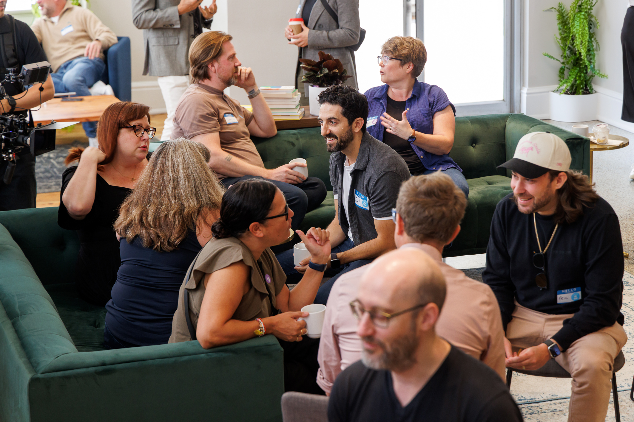 Image from a Raw Signal Group event featuring groups of people talking and smiling.