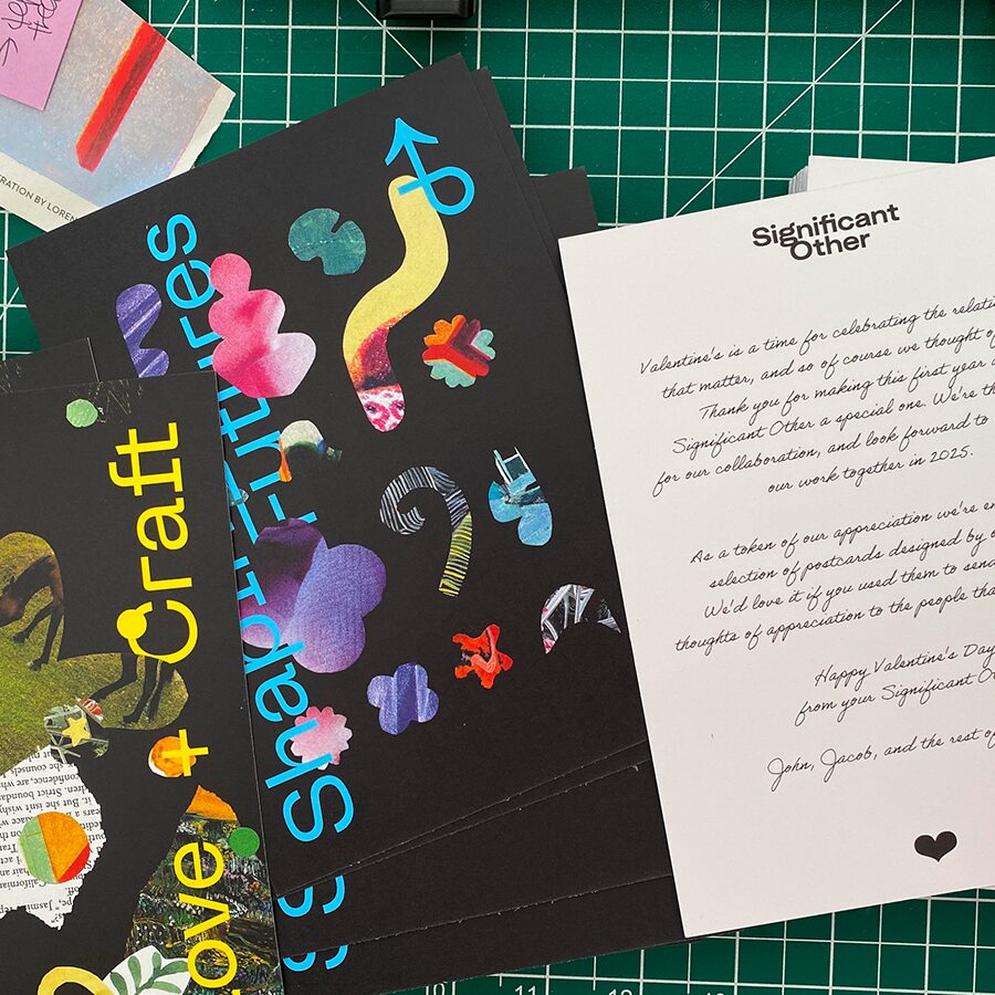 A top down view of a cutting boars scattered with brightly coloured collage cards with various phrases related to the practice of design.